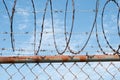 Barbwire fence closeup on sky - barb wire fence