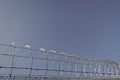 barbwire prison wall with barbed wire fence coiled razor wire perimeter fence, barbwire. Royalty Free Stock Photo