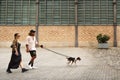 Barcelona - August 31, 2023: Couple walking with dog in the streets of the city of Barcelona next to Born.