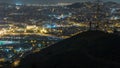 Barcelona and Badalona skyline with roofs of houses and sea on the horizon night timelapse