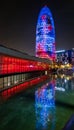 Disseny Hub Barcelona museum and Torre Glories at night, during LlumBCN lights festival.