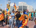 Young african male selling catalan independentist flags during the rally at La Diada, Catalonia`s National Day
