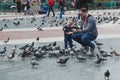 Barcelona, 04.2018, father and child feeding pigeons in Plaza Catalunya