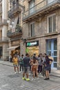 Barcelona - June 11, 2023: Exploring cannabis culture: a diverse group of people in front of a cannabis shop.