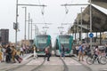 BARCELONA JUNE 14, 2019: Two tram trains on the rails and a crowd next to the tramway station in Barcelona