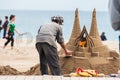 Sand sculptor working at La Barceloneta Beach in Barcelona Spain