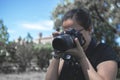 BARCELONA, MARCH 23: Young woman professional photographer taking pictures with a camera along an adventure travel