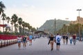 Barcelona, Oct 2021: People walking by the sea close to Colon statue Columbus in Barcelona, Montjuic mountain at the background Royalty Free Stock Photo