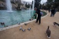 Barcelona, Parc Citadeli, March 2016: People feed ducks and pigeons in a city pond