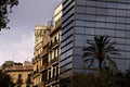 Barcelona`s architecture mix with palm tree reflected in window