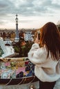 Barcelona signature style. modern tourist woman in coat at Guell Park in Barcelona