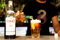 Barcelona, Spain - 20 april 2019: barman making famous british classic Pimm`s cocktail indoor on bar top with branded bottle