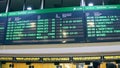 BARCELONA, SPAIN - APRIL, 15, 2017. Electronic departure board above ticket office at railroad terminal