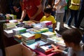 Barcelona, Spain - 23 April 2023: People are seen buying books while holding red roses during traditional catalan festivity of