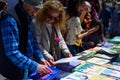 Barcelona, Spain - 23 April 2023: People are seen buying books while holding red roses during traditional catalan festivity of