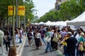 Barcelona, Spain - 23 April 2023: People are seen buying books while holding red roses during traditional catalan festivity of