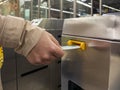 Woman hand inserting a metro ticket to enter a subway station Royalty Free Stock Photo