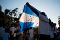 Barcelona, spain - 14 august 2019: people holding honduras flag protest agaist president juan orlando hernÃÂ¡ndez accused of being