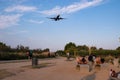 People taking pictures of a landing aircraft from the runway viewpoint of El Prat airport