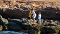 Barcelona, Spain, August 22, 2019: Three Brothers have fun fishing at the beach