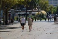 Barcelona, Spain, August 9, 2020: Tourist couple walking around in an empty La Rambla street wearing protective medical masks to