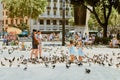 Barcelona, Spain -August 08, 2011: Two little sisters with parents walking in the square