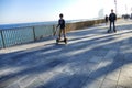 Barcelona Spain seafront perspective view of two children driving hoverboards