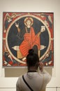 Visitor woman listen guide tour with headphone at National Art Museum of Catalonia