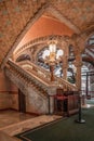Barcelona, Spain - Feb 24, 2020: Marble stairs with gleaming balustrades ceramic floral piles