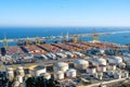 The commercial harbour of Barcelona with containers, cranes and storage tanks