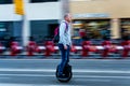 Barcelona, Spain - 20 february 2020_ man riding fast a modern mono wheel electric scooter in the city during the commute to work