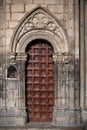 Ornate timber door and archway inside the Cathedral of Barcelona