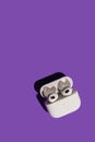 Barcelona, Spain - January 2022. New airpods pro in wireless charging case on violet background. Headphones, vertical Royalty Free Stock Photo