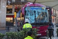 BARCELONA, SPAIN. JANUARY 02, 2016. A police officer tells the bus driver to safely drive a narrow crossroad in Barcelona. Spain e