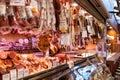 Barcelona, Spain - January 29 2018 : a variety of meats and sausages hanging in a stall on January 29 2018 , in La Boqueria,