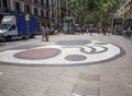 Barcelona, Spain Juan Miro mosaic with crowd on La Rambla area.