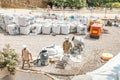 Builder man working with concrete cement mixer at construction site