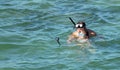 Barcelona, Spain, July 16, 2019: Father and daughter taking a selfie while snorkeling at the beach