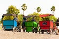 Barcelona, Spain - 7 july 2019: tricycle rickshaw immigrant drivers rest and talk at sunset in the city port. Rickshaw are now a