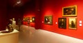 Visitors of national museum of Catalan visual art viewing paintings
