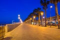 Boardwalk next to beach in Barcelona at night.