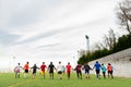 Barcelona, spain - 20 june 2020: a mixed race football team during practice holding hands, creating community and social inclusion