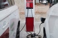 BARCELONA, SPAIN; JUNE 18th 2021: Electric car and hybrid car being charged with clean energy plug on street charging station