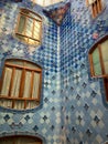 Interior of inner staircase chamber with windows and blue tiles in Casa BatllÃÂ³, designed by architect Antoni GaudÃÂ­.