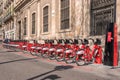 BARCELONA, SPAIN - MARCH 11: Line of red bicycles available for rental on the street of Barcelona city Royalty Free Stock Photo