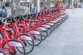 BARCELONA, SPAIN - MARCH 13: Line of red bicycles available for rental on the street of Barcelona city