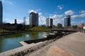 Barcelona,Spain, March 2016: pedestrian bridge and river in parc Diagonal Mar with view on modern skycaps