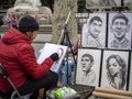 Street caricaturist painter working at La Rambla street, Barcelona