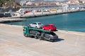 Barcelona, Spain - March 30, 2016: tow truck carry Seat and Mercedes cars in sea port. Auto export and import trade Royalty Free Stock Photo