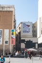 Walkers in Los Angeles square, center of the Raval neighborhood in Barcelona, very close to the Macba Museum. On the wall a mosaic